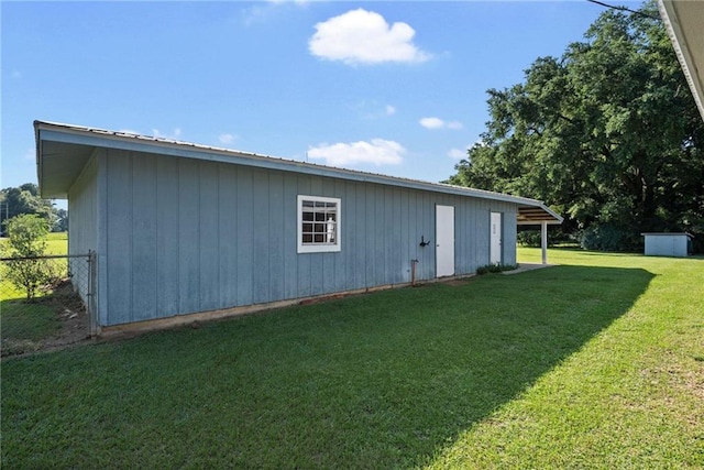 view of outbuilding with a lawn