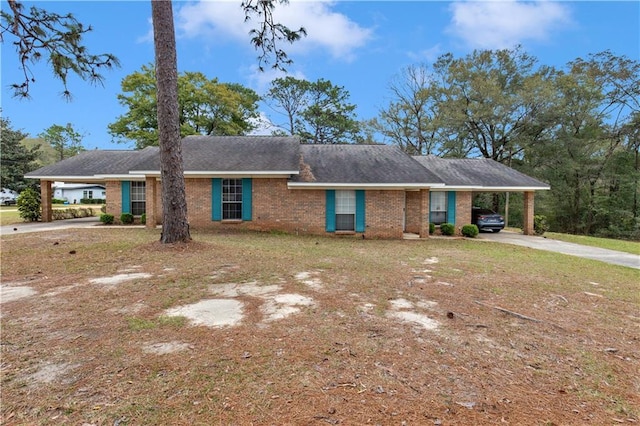 ranch-style house with an attached carport, concrete driveway, and brick siding