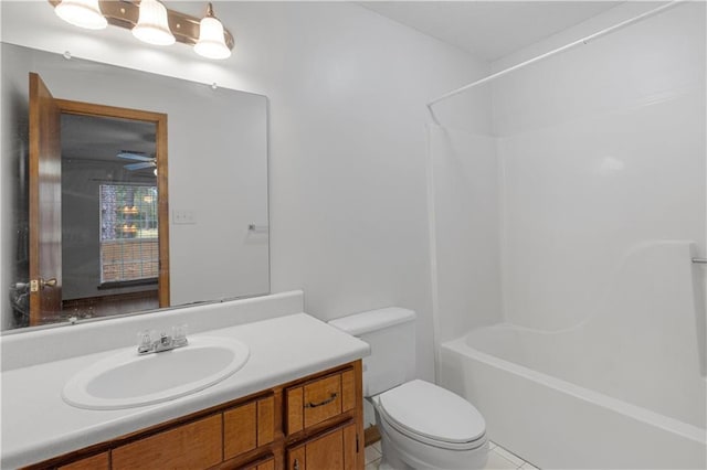 full bathroom with bathtub / shower combination, vanity, and toilet