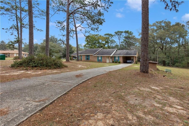 ranch-style home featuring concrete driveway