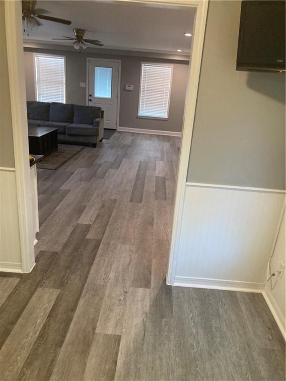 hall featuring ornamental molding and dark wood-type flooring