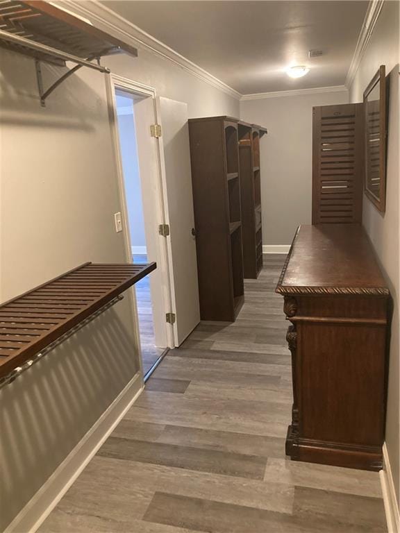 corridor with crown molding and wood-type flooring