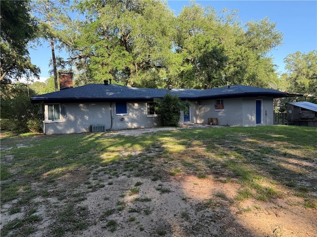 1137 Forest Ave, Saraland, AL 36571 - back of property featuring a lawn, central air condition unit, and a chimney