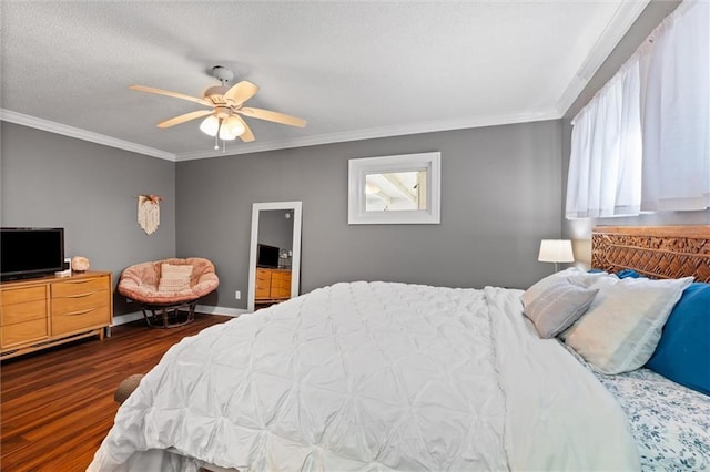 bedroom with a textured ceiling, dark wood-style floors, crown molding, baseboards, and ceiling fan