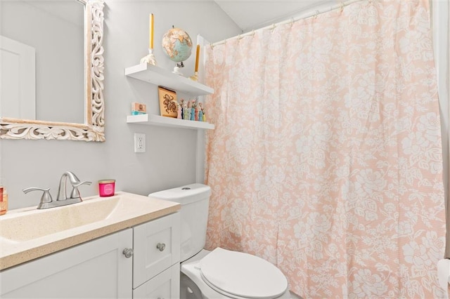 bathroom with vanity, curtained shower, and toilet