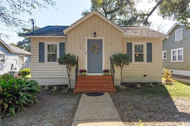 bungalow-style house with entry steps