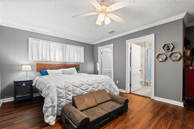 bedroom with a textured ceiling, wood finished floors, visible vents, and ornamental molding