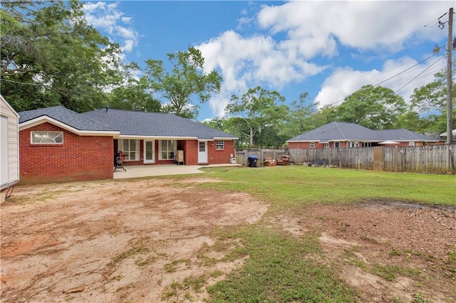 back of house featuring a patio area and brick siding