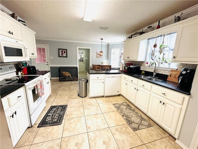 kitchen featuring pendant lighting, white appliances, sink, and light tile patterned floors