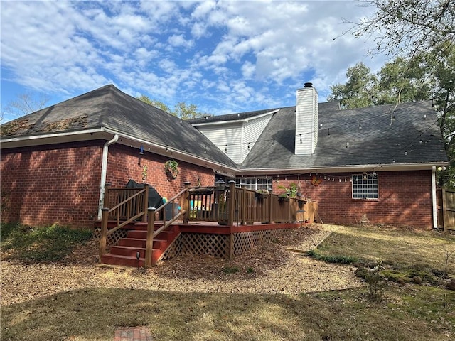 rear view of house with a yard and a deck