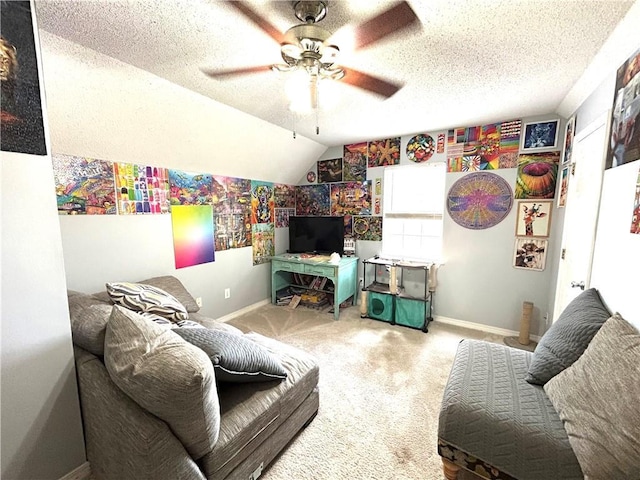 living room with lofted ceiling, ceiling fan, a textured ceiling, and carpet flooring