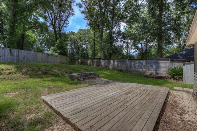 wooden terrace featuring a lawn