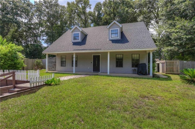 128 Richmond Rd, Daphne, AL 36526 - view of front of home featuring a shingled roof, fence, and a front lawn