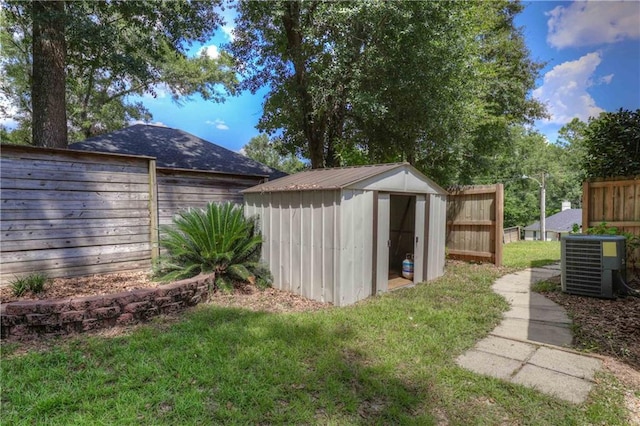 view of yard with cooling unit and a shed