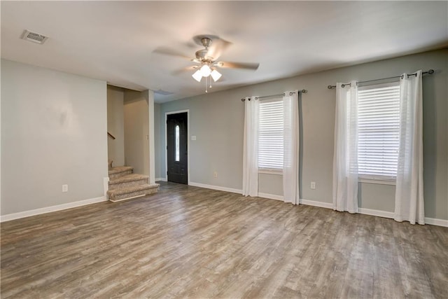 128 Richmond Rd, Daphne, AL 36526 - unfurnished living room featuring visible vents, ceiling fan, wood finished floors, and stairway