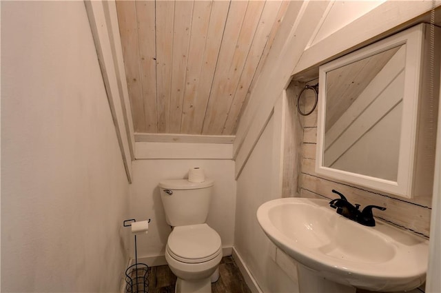 bathroom with toilet, hardwood / wood-style floors, sink, wooden ceiling, and lofted ceiling