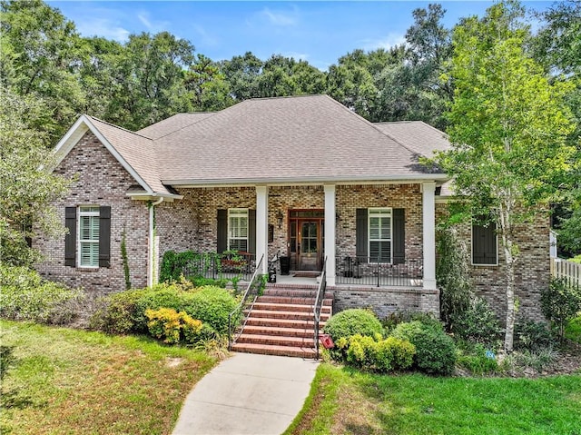 view of front of house featuring a front yard and covered porch