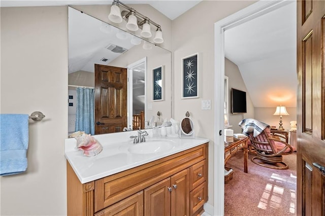 bathroom with walk in shower, lofted ceiling, and vanity