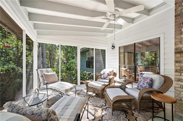 sunroom featuring lofted ceiling with beams and ceiling fan