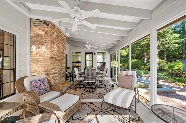 sunroom / solarium featuring lofted ceiling with beams and ceiling fan