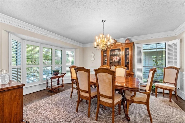 dining space featuring a textured ceiling, crown molding, dark wood-type flooring, and a healthy amount of sunlight