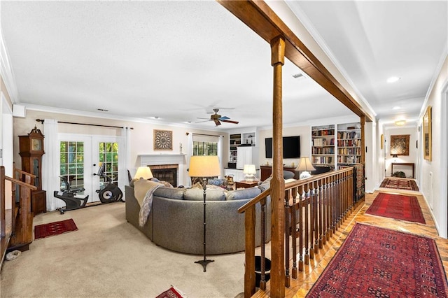 living room featuring ornamental molding, ceiling fan, carpet floors, and french doors