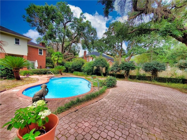 pool featuring a patio area and fence