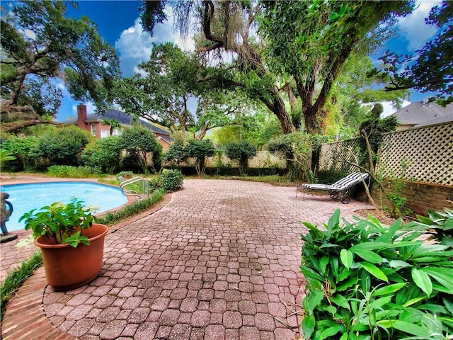 view of swimming pool featuring a fenced in pool, fence, and a patio area