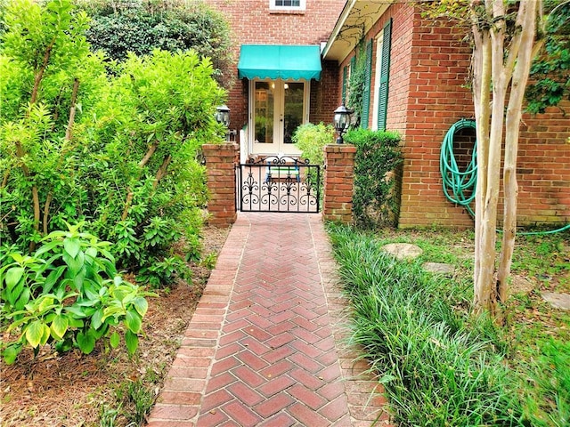 exterior space with french doors and brick siding