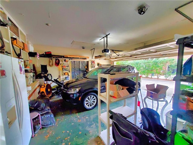 garage with white fridge with ice dispenser