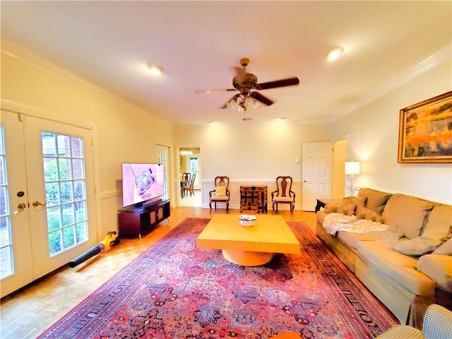 living room with french doors, a ceiling fan, and ornamental molding