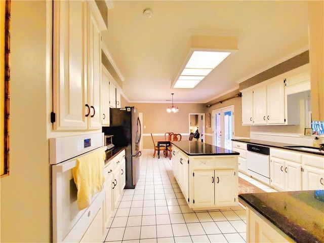 kitchen featuring a kitchen island, ornamental molding, light tile patterned flooring, white appliances, and a sink