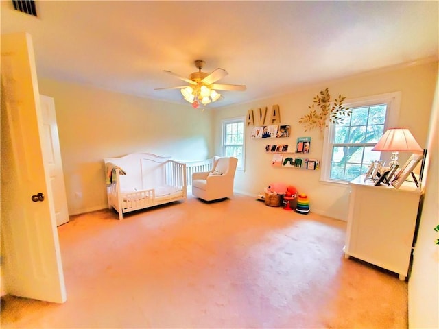 carpeted bedroom with visible vents, ceiling fan, and baseboards