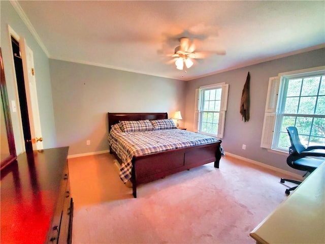 bedroom featuring crown molding, carpet flooring, a ceiling fan, and baseboards