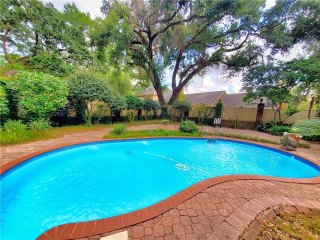 view of swimming pool with a fenced in pool and fence