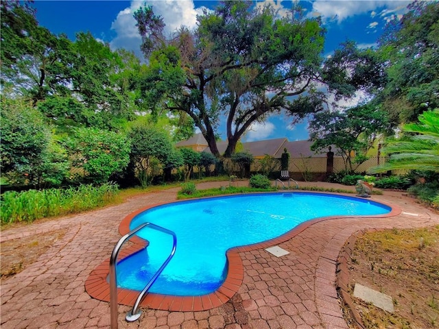 view of swimming pool with a patio area, a fenced in pool, and fence