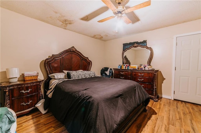 bedroom with baseboards, wood finished floors, and a ceiling fan