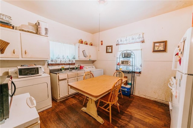 kitchen featuring a healthy amount of sunlight, white appliances, and washer / clothes dryer