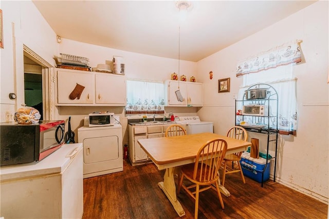 dining room with dark wood finished floors and washer / dryer