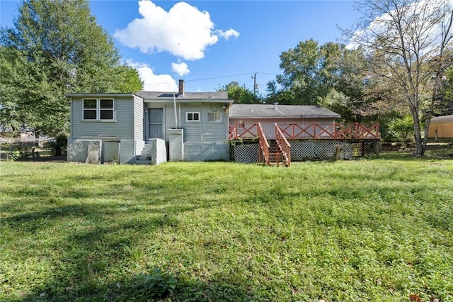 rear view of property featuring a yard