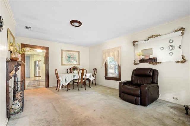 dining room with carpet floors and ornamental molding