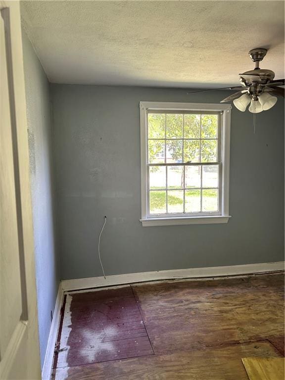 2365 Dog River Dr N, Mobile, AL 36605 - empty room with a textured ceiling, ceiling fan, and wood finished floors