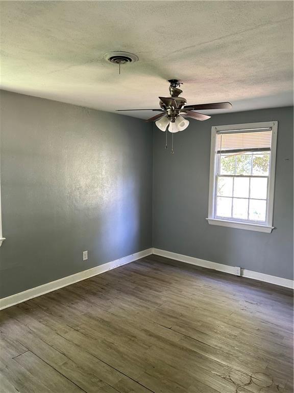 2365 Dog River Dr N, Mobile, AL 36605 - unfurnished room with a ceiling fan, dark wood-style floors, and a textured ceiling