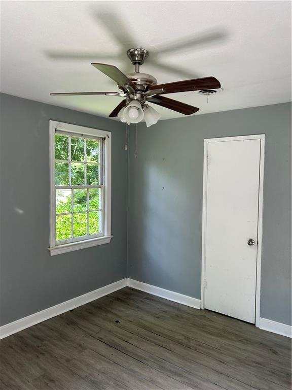 2365 Dog River Dr N, Mobile, AL 36605 - empty room with dark wood-style floors and ceiling fan