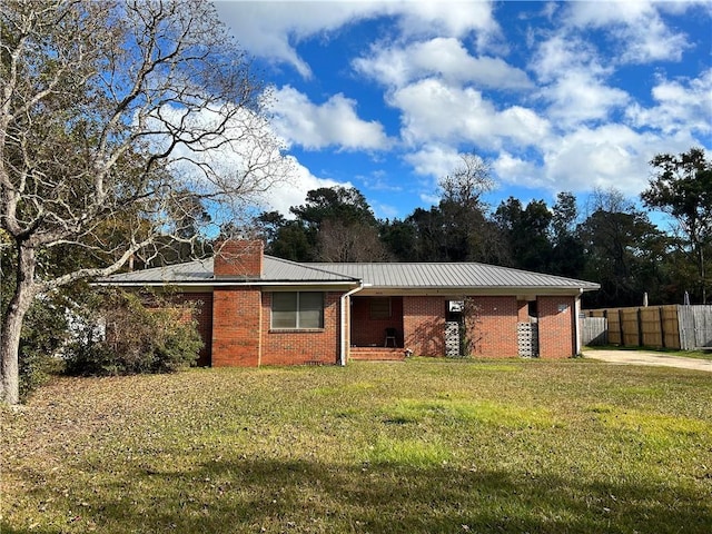 ranch-style home with a front lawn