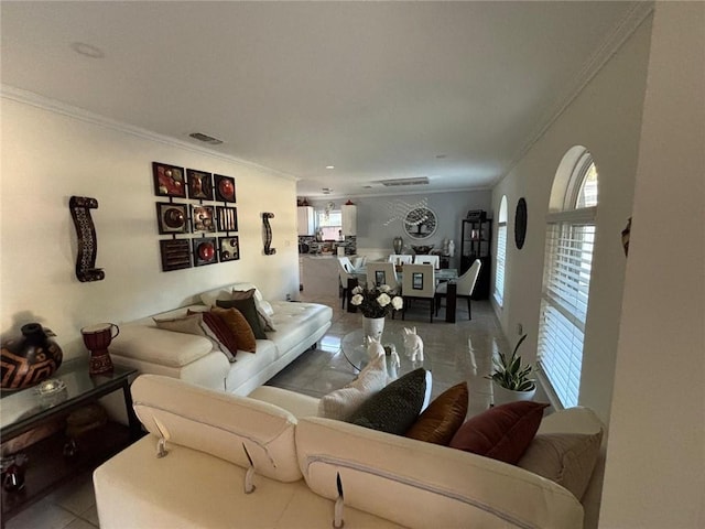 living room featuring ornamental molding and light tile patterned floors