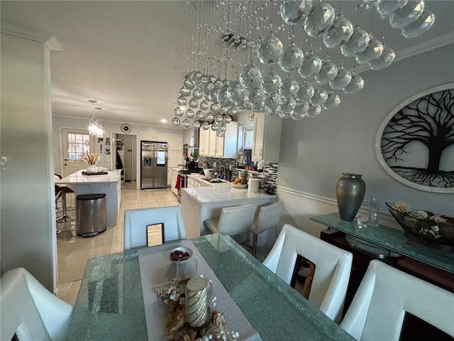 tiled dining area featuring ornamental molding