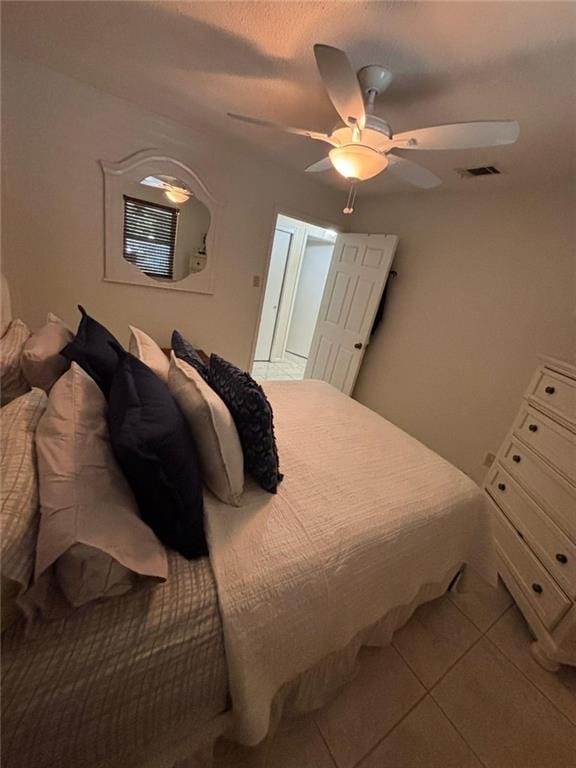 bedroom featuring ceiling fan and light tile patterned floors