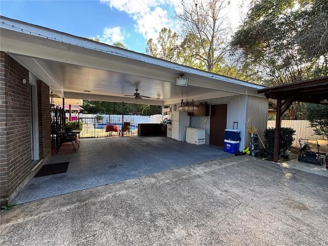 view of parking with a carport and ceiling fan