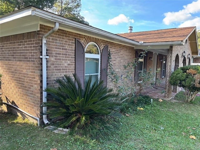 view of side of property with a lawn